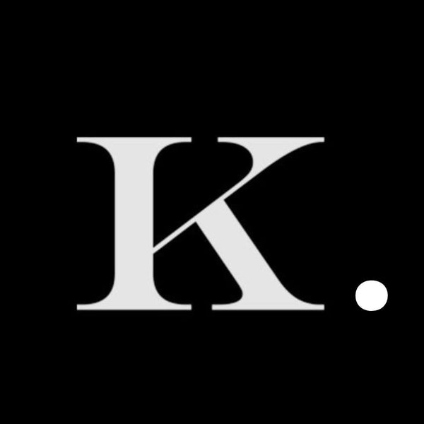 Stylized white letter K with a diagonal slash and a white dot on black background, minimalist logo design.